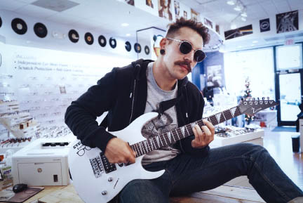 Man Playing Guitar with Glasses