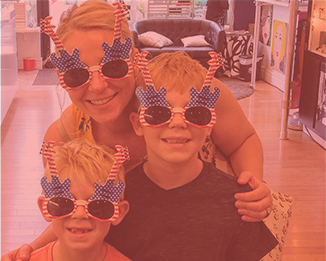 Mother and her sons wearing american flag guitar shaped glasses