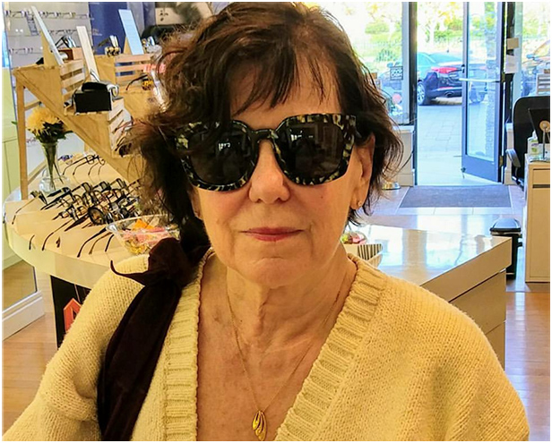 Older woman trying on Eye Roc Sunglasses