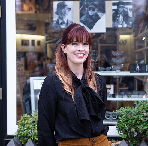 Dr. Kate Gettinger, a contact lens and dry eye expert, standing outside of Eye Roc Eyewear.