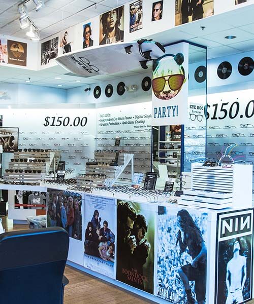 Interior of Eye Roc eyeglasses shop with eyeglasses on the walls and counter tops.