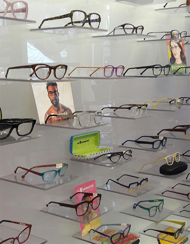 A close up view of eyeglasses displayed on a wall.