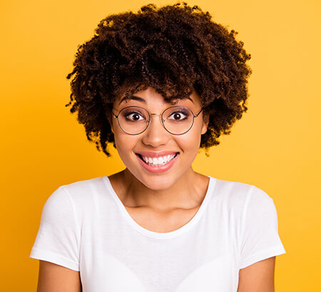 Woman staring straight into the camera wearing round eyeglasses