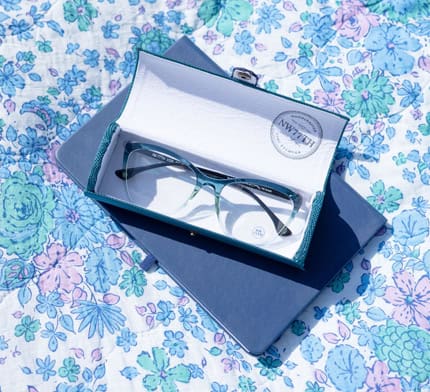Woman staring straight into the camera wearing round eyeglasses